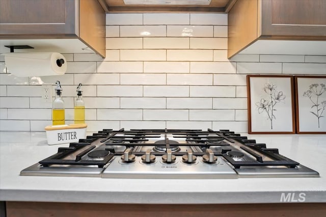 room details with backsplash and stainless steel gas cooktop