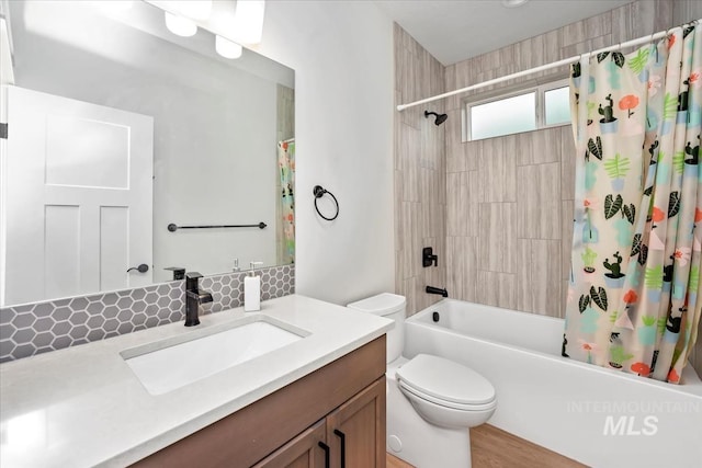 full bathroom featuring tasteful backsplash, vanity, toilet, and shower / bath combo with shower curtain