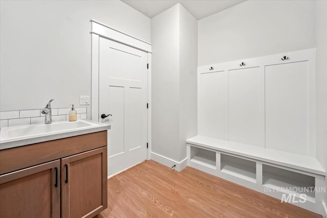 mudroom featuring sink and light hardwood / wood-style floors