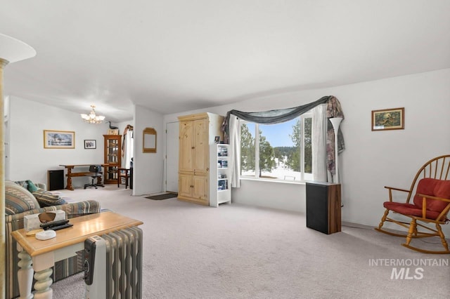 living room featuring an inviting chandelier, radiator heating unit, and light colored carpet