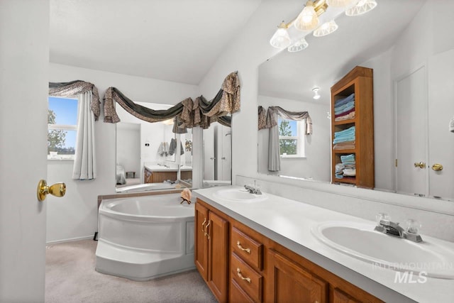 full bath featuring a garden tub, a sink, and double vanity