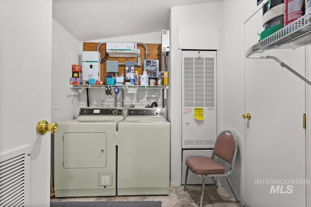 laundry room with visible vents and washer and dryer