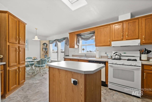 kitchen with light countertops, white gas stove, under cabinet range hood, and dishwasher