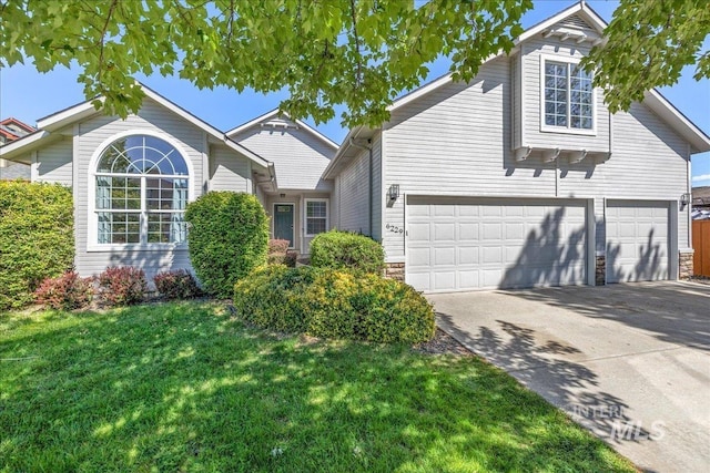6229 S Snowdrop Way, Boise, ID 83716 - traditional-style house with concrete driveway, a front lawn, and stone siding