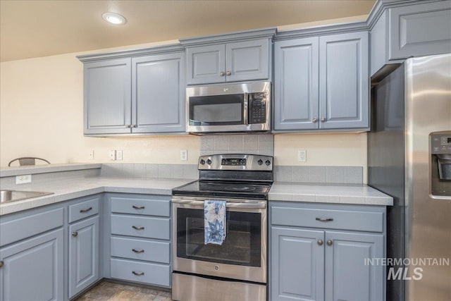 6229 S Snowdrop Way, Boise, ID 83716 - kitchen with stainless steel appliances, gray cabinetry, and recessed lighting