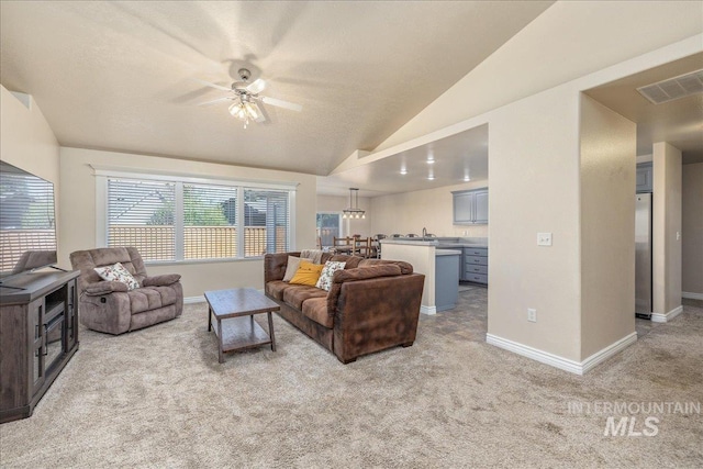 6229 S Snowdrop Way, Boise, ID 83716 - living room featuring light colored carpet, a ceiling fan, baseboards, and vaulted ceiling