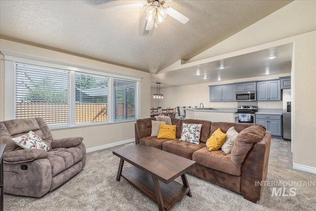 6229 S Snowdrop Way, Boise, ID 83716 - living room featuring light carpet, baseboards, ceiling fan, lofted ceiling, and a textured ceiling