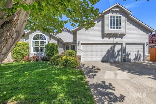 6229 S Snowdrop Way, Boise, ID 83716 - traditional home with stone siding, concrete driveway, a front yard, and a garage