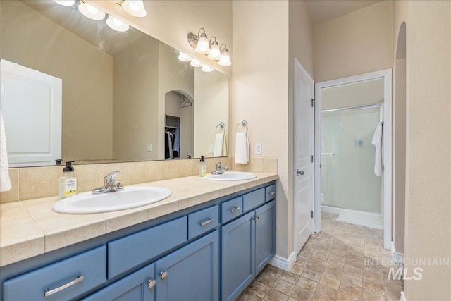 6229 S Snowdrop Way, Boise, ID 83716 - bathroom with double vanity, an enclosed shower, baseboards, a spacious closet, and stone finish flooring