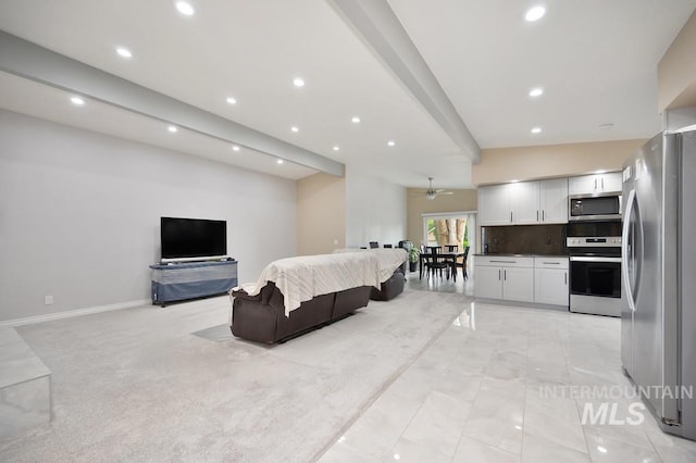 carpeted living room with ceiling fan