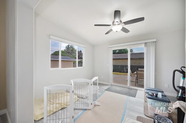 bedroom with hardwood / wood-style flooring, ceiling fan, lofted ceiling, and access to outside