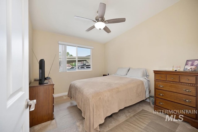 carpeted bedroom with ceiling fan and vaulted ceiling