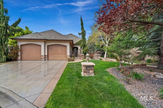 view of front of home with driveway, a front yard, a garage, a shingled roof, and stucco siding