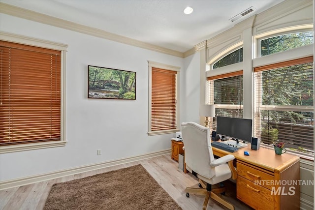 office area featuring visible vents, ornamental molding, baseboards, and light wood-type flooring