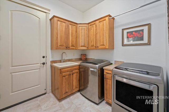 interior space featuring a sink, light countertops, and washer and dryer
