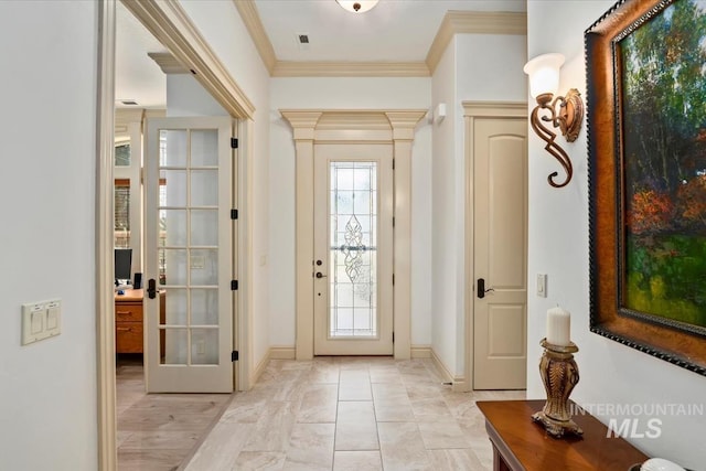 doorway with baseboards, ornamental molding, and french doors