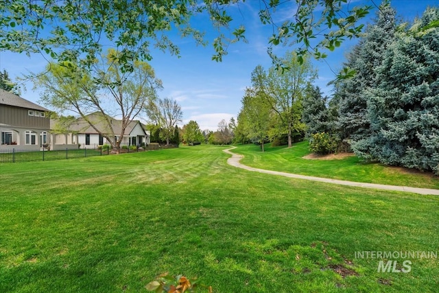 surrounding community with a yard and fence