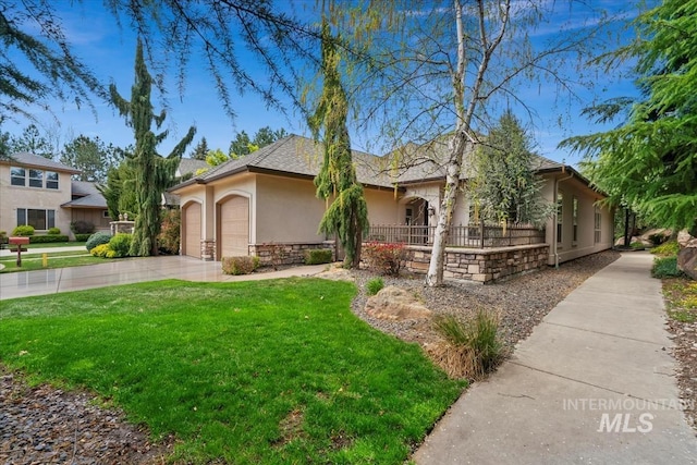 view of front of house featuring a front yard, stone siding, stucco siding, an attached garage, and driveway