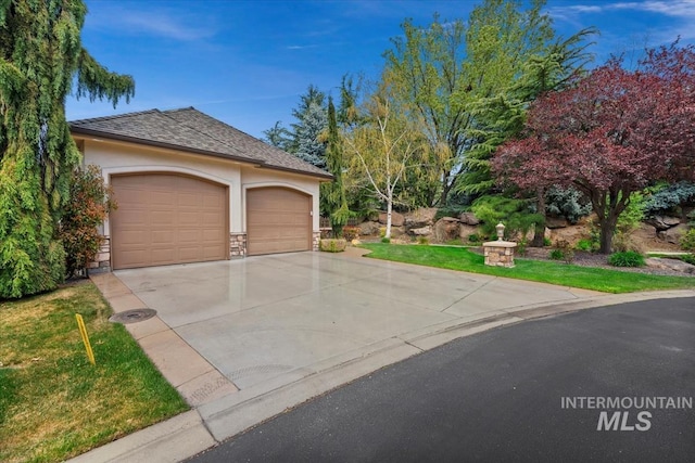 exterior space with stone siding, stucco siding, a shingled roof, concrete driveway, and an attached garage