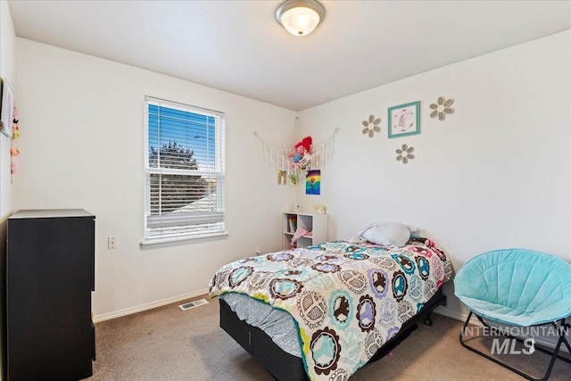 carpeted bedroom featuring visible vents and baseboards
