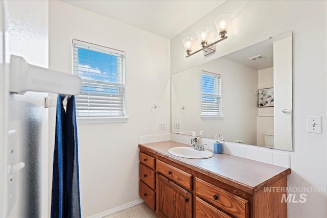 bathroom featuring toilet and vanity