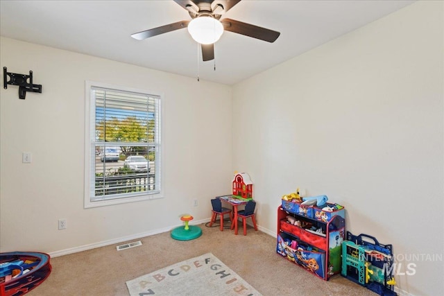 playroom with light colored carpet and ceiling fan