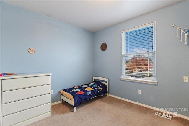 bedroom featuring light colored carpet