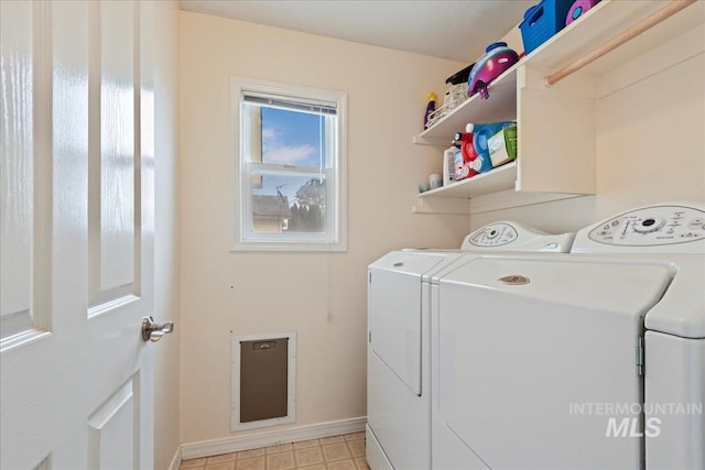 laundry room featuring laundry area, baseboards, and washing machine and clothes dryer