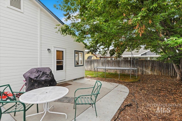 view of patio featuring a fenced backyard and a trampoline