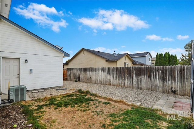view of yard with a fenced backyard and cooling unit