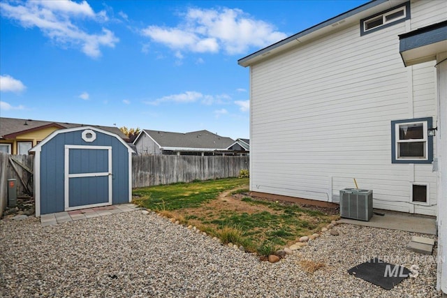 view of yard featuring a shed and central AC unit