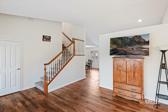 stairway with recessed lighting, baseboards, wood finished floors, and lofted ceiling