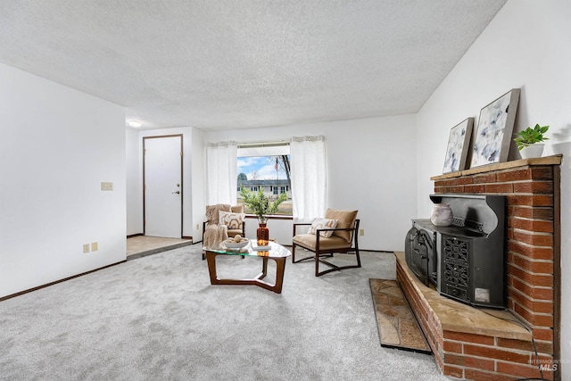 carpeted living area with baseboards and a textured ceiling