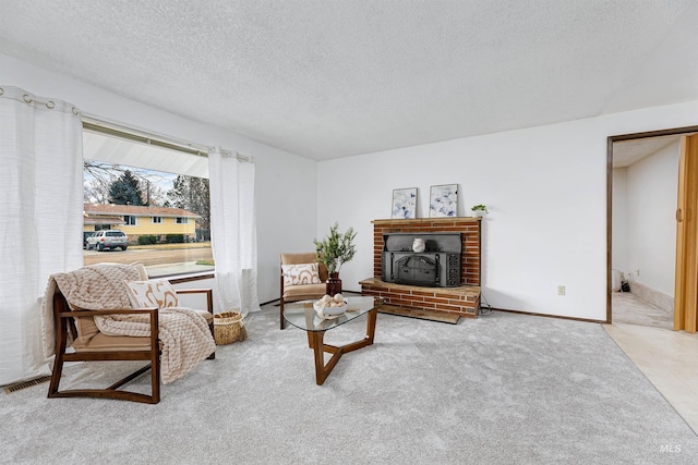 living room featuring visible vents, carpet flooring, a textured ceiling, and baseboards