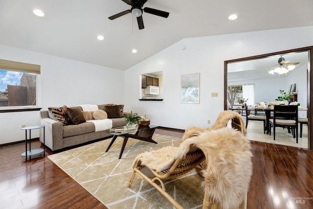 living area featuring baseboards, ceiling fan, vaulted ceiling, recessed lighting, and dark wood-style flooring