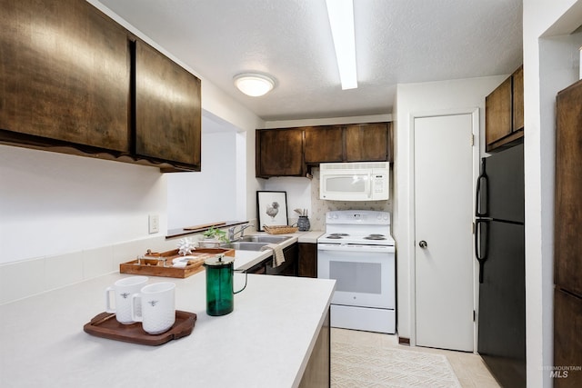 kitchen with a sink, a textured ceiling, white appliances, light countertops, and dark brown cabinets