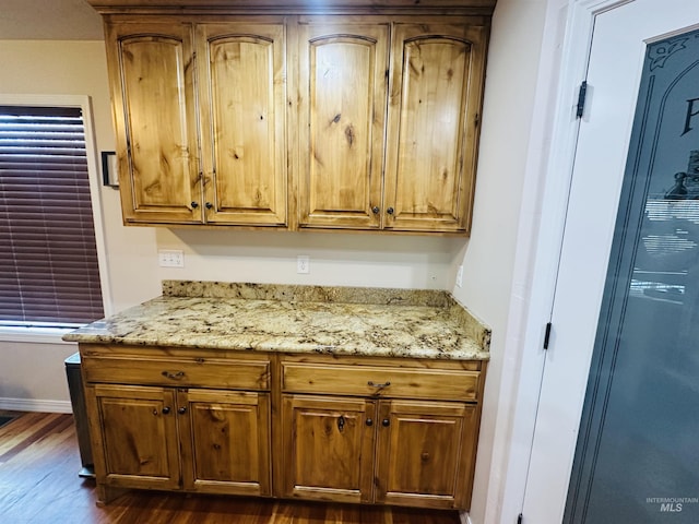 382 N 1020 E, Declo, ID 83323 - kitchen with brown cabinetry, light stone countertops, baseboards, and dark wood finished floors