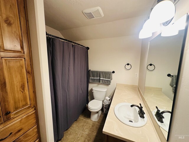 382 N 1020 E, Declo, ID 83323 - full bathroom with toilet, visible vents, tile patterned flooring, vanity, and vaulted ceiling
