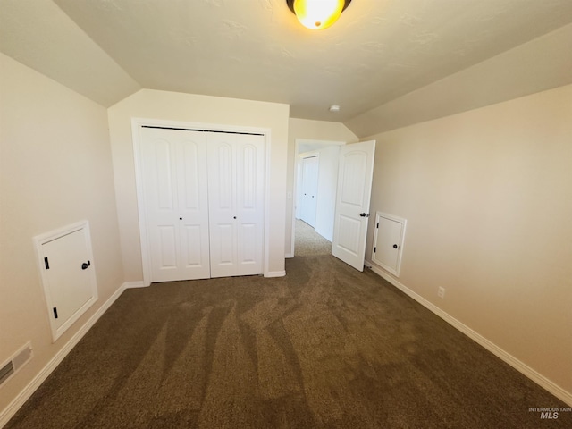 382 N 1020 E, Declo, ID 83323 - unfurnished bedroom featuring visible vents, baseboards, a closet, lofted ceiling, and dark carpet