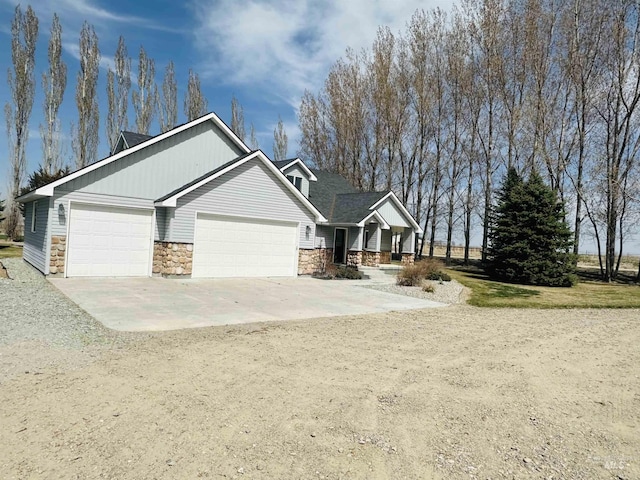 382 N 1020 E, Declo, ID 83323 - craftsman-style house with stone siding, driveway, and a garage