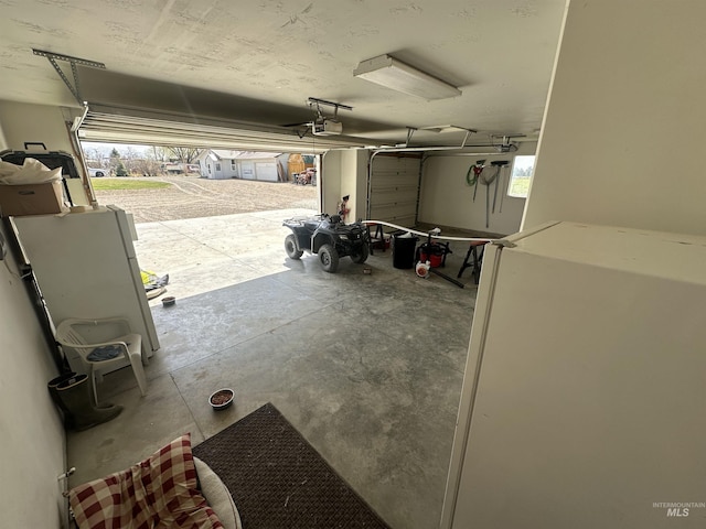382 N 1020 E, Declo, ID 83323 - garage with freestanding refrigerator and a garage door opener
