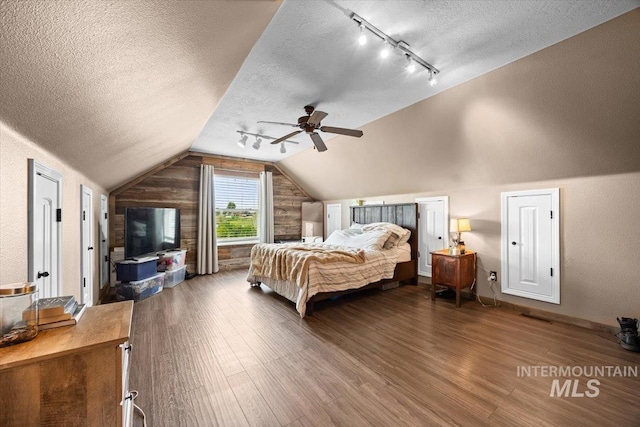 3856 Wood Way, New Plymouth, ID 83655 - bedroom with track lighting, a textured ceiling, wood finished floors, and lofted ceiling