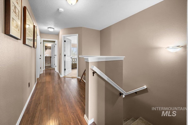 3856 Wood Way, New Plymouth, ID 83655 - hallway with baseboards, wood finished floors, and an upstairs landing