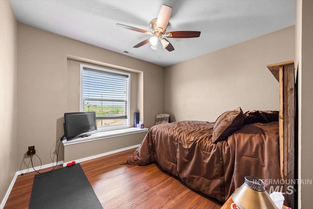 3856 Wood Way, New Plymouth, ID 83655 - bedroom featuring visible vents, a ceiling fan, baseboards, and wood finished floors