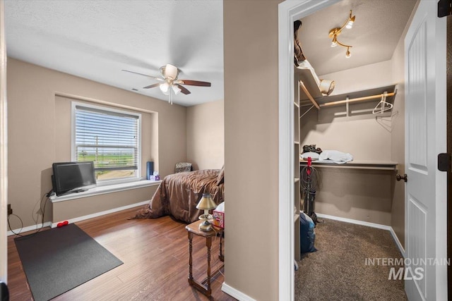 3856 Wood Way, New Plymouth, ID 83655 - bedroom with baseboards, a ceiling fan, a textured ceiling, and wood finished floors