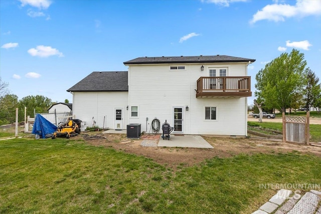 3856 Wood Way, New Plymouth, ID 83655 - back of property featuring french doors, central AC unit, a balcony, a yard, and a patio