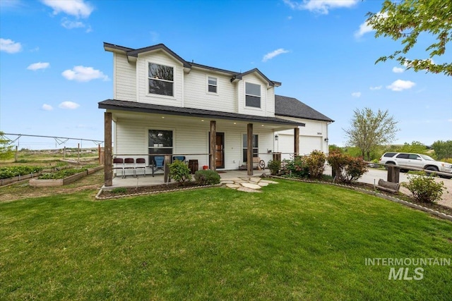 3856 Wood Way, New Plymouth, ID 83655 - view of front of home featuring an attached garage, a front lawn, a vegetable garden, and a porch