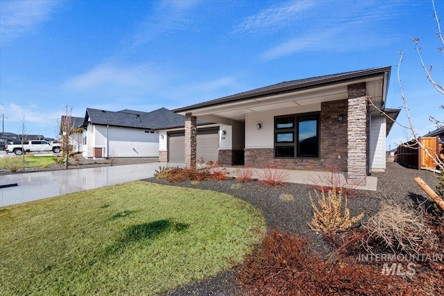 view of front of home featuring stone siding, an attached garage, concrete driveway, and a front lawn