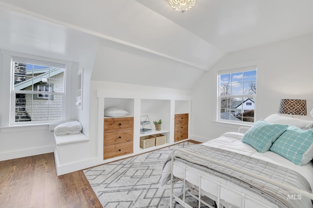 bedroom with lofted ceiling and hardwood / wood-style flooring