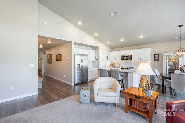 3772 S Walnut Ridge Way, Nampa, ID 83686 - living area with recessed lighting, dark wood finished floors, a chandelier, and lofted ceiling